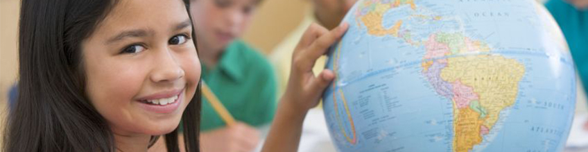 A Girl pointing to a globe, to illustrate that TimeTabler School Scheduling Software is used WorldWide